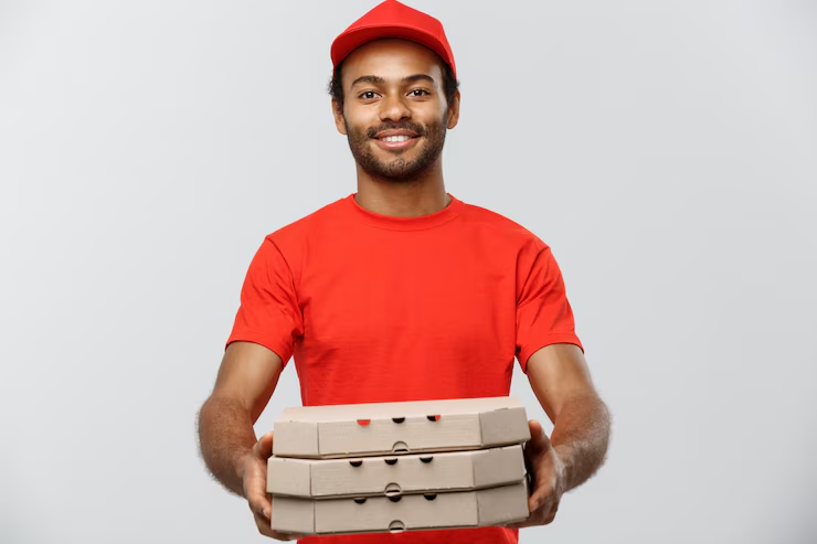 A happy delivery executive handing you your pizzas